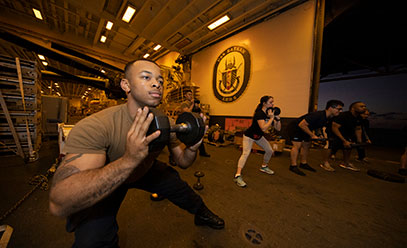 Service Members working out with dumbbells