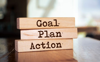 Little wooden blocks with the words Goal Plan Action on them