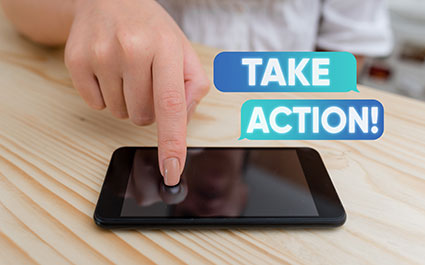 Woman's hand touching the screen of a mobile phone. The words take action float above.