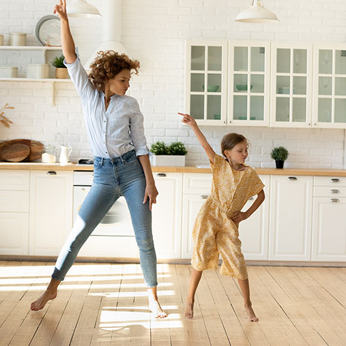 Mother and daughter dancing to music