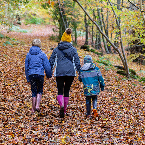 Woman and her children walking a trail bundled in winter clothes