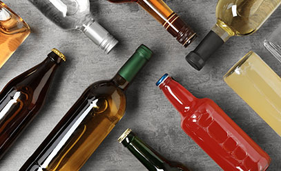 Photo of different alcohol bottles laying flat and perpendicular to each other