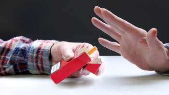 One hand offers a cigarette, another refuses