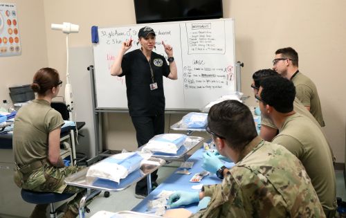 Lisa Deisch, medical instructor, U.S. Army John F. Kennedy Special Warfare Center and School, teaches students who are in the Special Operations Combat Medic Course suturing skills during training at the Joint Special Operations Medical Training Center at Fort Bragg, North Carolina March 5, 2019. 